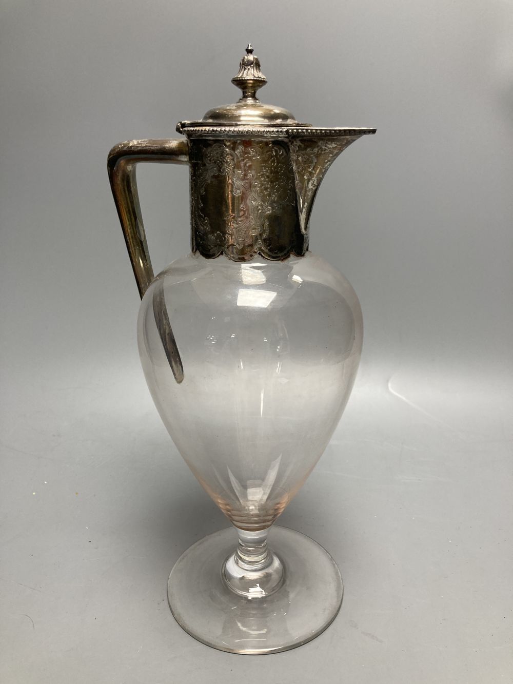 An Edwardian engraved silver mounted inverted pear shaped pedestal glass claret jug, Atkin Brothers, Sheffield, 1906?, 28.8cm.